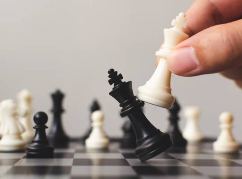 Plan leading strategy of successful business competition leader concept, Hand of player chess board game putting white pawn, Copy space for your text